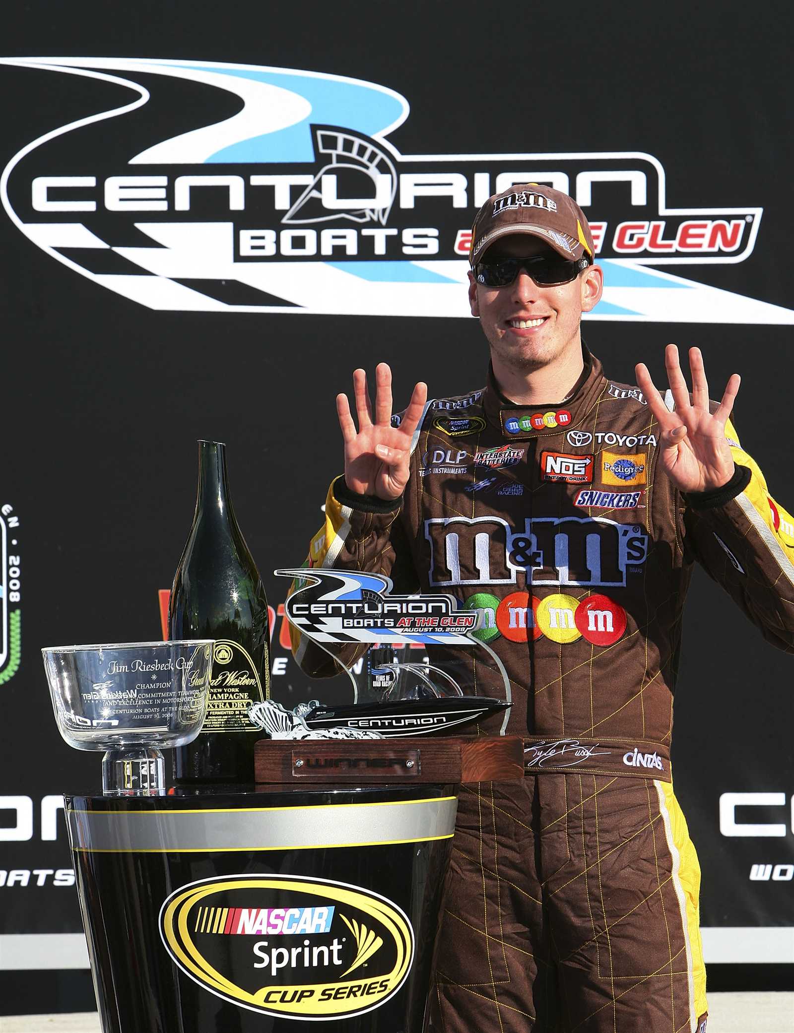 <p><u> Aug. 10, 2008</u><br />Kyle Busch shows that his No. 18 M&M's Toyota team has claimed its eighth win of the season in the Centurion Boats at the Glen. It also marked Joe Gibbs Racing's fifth victory out of seven Cup Series races at Watkins Glen International. The win locked up the top seed in the NASCAR Playoffs for Busch.</p>
